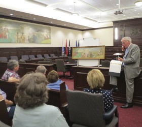 Chester County Court Judge Thomas G. Gavin discusses what little information is known about the 1956 mural by Edward Shenton. Behind him is the model painting that differs in numerous small ways from the finished product.