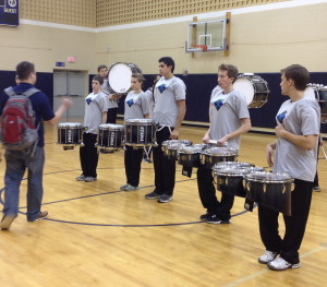 Unionville Drumline Coach Cody Stafford gives his musicians instruction before a recent performance.