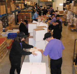 A high-energy crew of Wegmans employees formed an assembly line to sort the donation of 18,000 pounds of food.