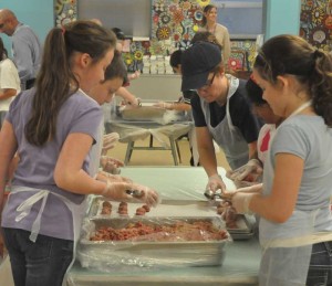 Unionville Elementary School students prepare meatballs from this Saturday's United Way of Southern Chester County/Unionville Chadds Ford School district annual Pasta Dinner. More than a dozen students, along with administrators, teachers, food service workers, gathered Tuesday to make meatballs.