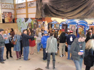 Spectators mingle and survey the art at Bam Margera's skate park, which doubled as a gallery Tuesday night.