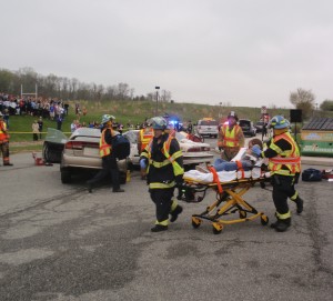 First-responders wheel one of the injured teens to a waiting ambulance.