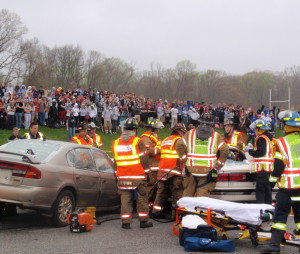 First-responders work to extricate the students trapped in the vehicle during the mock crash exercise.