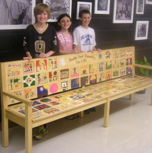 Fifth-graders Michael Walter-Dillon (from left), Katelyn Kurkewicz, and Peter Kucharczuk show off their memory-layered gift to the school.