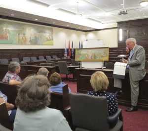 Chester County Court Judge Thomas G. Gavin discusses what little information is known about the 1956 mural by Edward Shenton. Behind him is the model painting that differs in numerous small ways from the finished product.