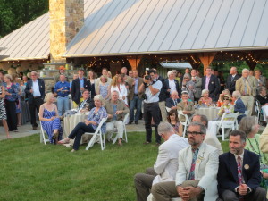 Attendees at Friday's fund-raiser pause from conversations in and around the outdoor pavilion as the Lenfests welcome them to the Lenfest Center at the ChesLen Preserve in Newlin Township. 