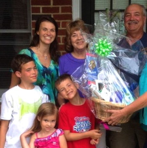 Lucky landowners Joe (counterclockwise from top right) and Billie Teti display their winnings with their  daughter Michelle and their grandchildren: Jamison, 10; Mollie, 3; and Colin, 7.   