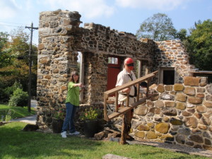 Artist Adrian Martinez (right) gets into position at Martin's Tavern in Marshallton so his wife, Leah Martinez, can photograph the scene, which will 