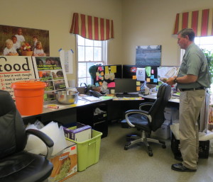 Larry Welsch, executive director of the Chester County Food Bank, surveys some of the current office space, which features overflow storage on the floor.  