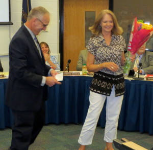 Linda Feathers, who retired as a technology support specialist at Hillendale Elementary, receives flowers from Principal Steve Dissinger.