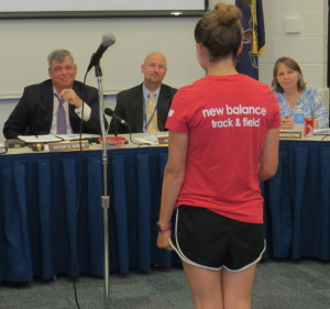 Board member Victor Dupuis (from left), Superintendent John Sanville, and board member Holly Manzone listen as Unionville track star Olivia Young explains why the  team needs more coaching support. 
