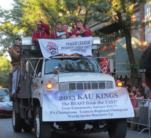 Members of the championship KAU baseball team wave to the crowds during Friday night's 2013 Mushroom Festival Parade.