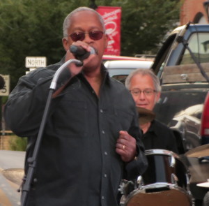 Borough Councilman Leon Spencer, a member of the band Good Foot, urges the crowd to have a “good, good night” at the post-parade festivities of the Mushroom Festival.