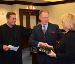 Chester County Court Judge Anthony A. Sarcione (from left) congratulates Chief Deputy Sheriff George P. March and Sheriff Carolyn "Bunny" Welsh, who held the Bible during March's swearing-in.