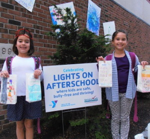Two girls from the YMCA of the Brandywine Valley after-school program proudly display the luminary bags they created for the National initiative, "Lights on Afterschool." This year’s event will take place on Thursday.