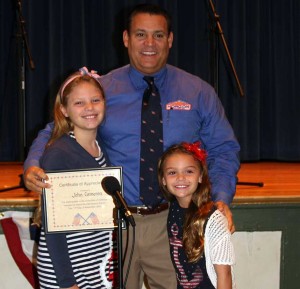 Unionville Elementary students Madeleine and Holly Cameron honor their dad, John Cameron, at the Veterans Day assembly held Monday at Unionville Elementary School.