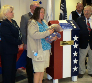 As Chester County Sheriff Carolyn "Bunny" Welsh (left) looks on, Veronica Hoadley briefly explains the history of the flags she retired.