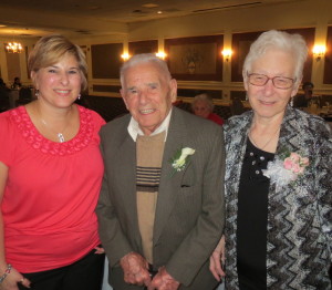 Enjoying his 100th birthday party, Mike DiPietro is flanked by his daughter, Lisa, and his wife, Teresa.