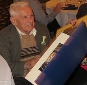 Mike DiPietro reads the many greetings that he received on his 100th birthday.