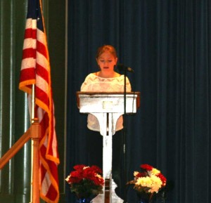 Unionville Elementary School fifth grader, Kate Holmes, talks about the history of Veterans Day at the school's special assembly.