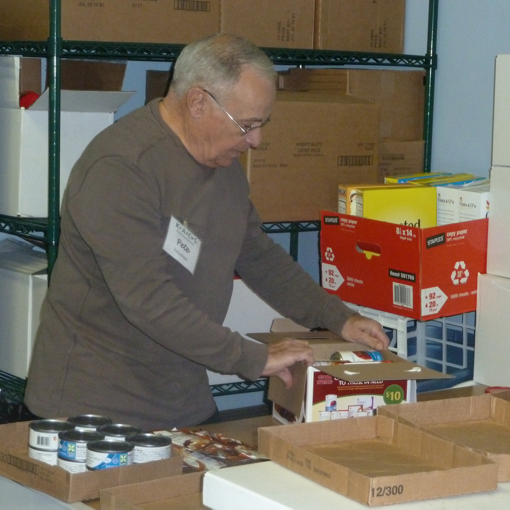 Kennett Food Cupboard Volunteer Pete D'Angelo prepares for one of the busiest times of the year as volunteers and staff sort through donations in anticipation of the Thanksgiving holiday.