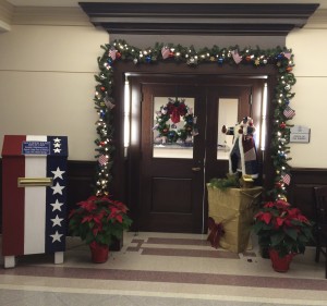 The Chester County Sheriff’s Office patriotic holiday door display in the lobby of the Chester County Justice Center is now anchored by a new box, where residents can deposit U.S. flags they want to retire.