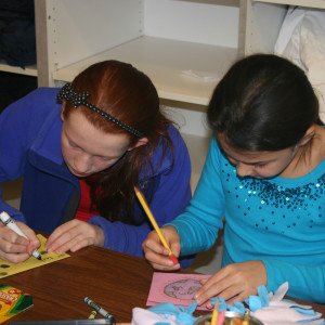 Unionville Elementary students Taryn Blecher (left) and Jessica Hall (right) decorate a card and write words of encouragement for sick children at A.I. duPont Hospital for Children.