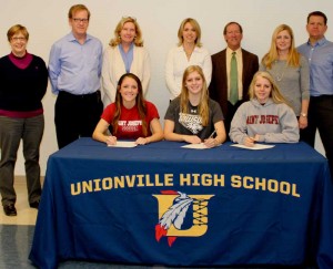 Three Unionville High School athletes announced this week that they would continue their sports careers in college: Seated from L to R are Caroline Miller, who will attend St. Joseph's, Madison Bove, who attend Towson St. in Maryland, and Janine Mueller  who will attend St. Joseph's. Pictured with the athletes from left to right are: UHS principal Paula Massanari, William and Regina Miller, Kim Bove,  UHS Soccer Coach Joe Ratasiewicz and Janine and Thomas Mueller.