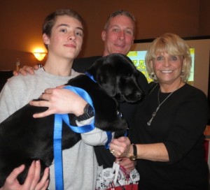 Chester County Sheriff Carolyn “Bunny” Welsh poses with the winner’s of the black Lab, which came from Cedar Creek Farm in Nottingham: Jake Read (from left), and his father, Matthew Read. The pair said they purchased the puppy for Jake’s grandmother.