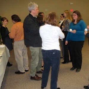 Volunteers and service providers involved in the Point-in-Time Count discuss the results with county workers, including Sarah Trentley (left) and Heather N. Charboneau (right).