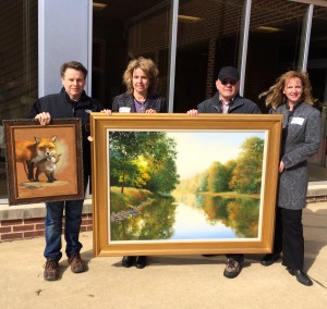 Displaying two of the oil paintings for the 65th Annual Chadds Ford Art Sale and Show are artist Shawn Faust (from left), co-chair Frances Galvin, artist J. Wayne Bystrom, and co-chair Lynda Nadin. 