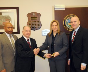 New Chester County Detective Kristin Lund is congratulated by Lt. Kevin Dykes (from left), Chief Detective James Vito, and District Attorney Tom Hogan.