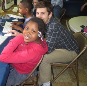 Second-grader Kanya Phipps (left), assisted by Unionville High senior Ari Bleemer, takes a break from her computer work at Study Buddies.