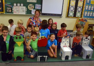 Kindergarten students from Hillendale Elementary School with the new chairs, hand-made by seventh and eighth grade students at Patton Middle School, after the older students delivered them in person earlier this month.
