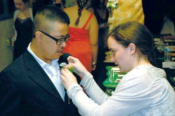 Eric Juarez, a CCDC student, has his prom corsage pinned on by a student volunteer from Downingtown Area School District.