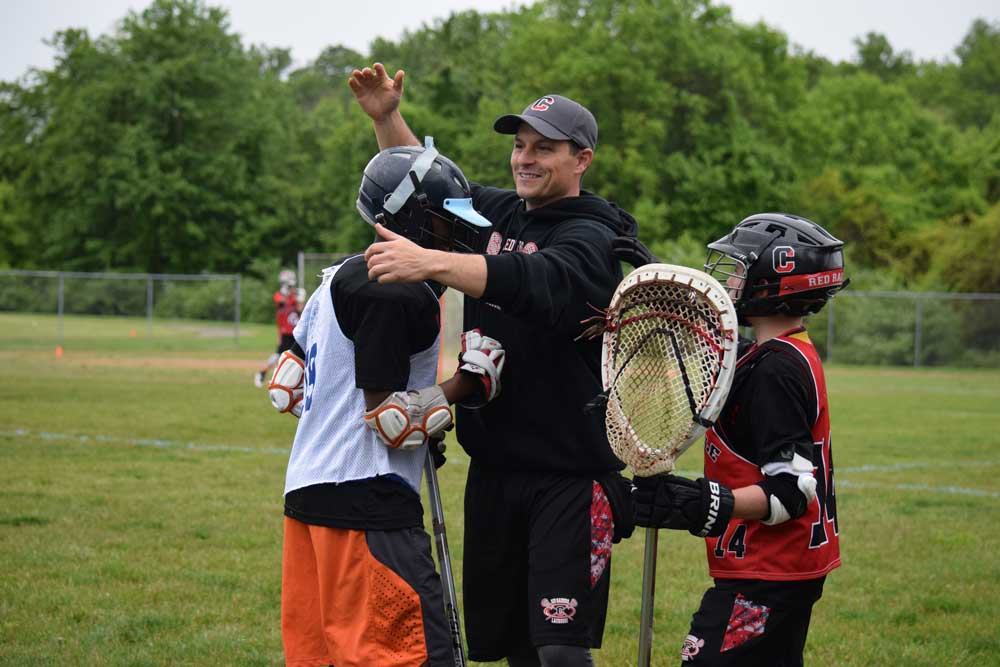 CYL coach Darrell Wilder, congratulated one of the HLL players he and his family hosted at their house Saturday night. Credit: Stacy Geyer