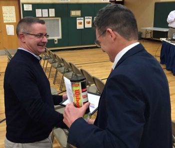 Pocopson Elementary School Principal Clif Beaver offers congratulations to retiring teacher Dennis Nelms during Monday night's Board of Education meeting.