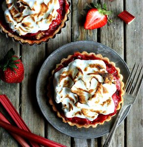 These individual tartlets combine the best of spring strawberries with the tart taste of their spring partner, rhubarb. Photo courtesy of Annalise at Completely Delicious.