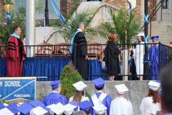 Kennett Consolidate School District Board of Education President Kendra LaCosta presents diplomas to graduates of Kennett High School, Friday night.