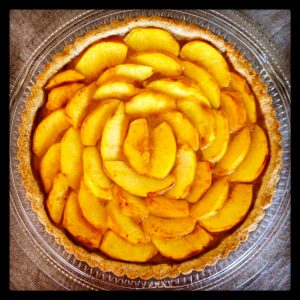 Whether artfully arranged in a tart as shown here, made into a crumble or served warm in a pie, baked peaches make for summer delicacies. Photo courtesy of Simona Carini