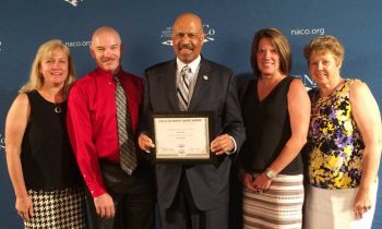 Representatives from the Chester County Intermediate Unit (CCIU) joined Chester County Commissioners’ Chair Terence Farrell in accepting the National Association of Counties (NACo) Achievement Award for Employment and Training at NACo’s annual conference in Long Beach, California. Pictured from left to right are: Dr. Jacalyn Auris and Mr. R. Scot Semple from the CCIU, County Commissioner Terence Farrell, and Laurie Masino and Dr. Anita Riccio, also from the CCIU.