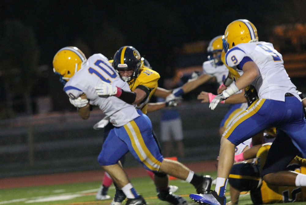 Cougars' running back Daniel Liaudatis (10) powers into the secondary, Friday against Unionville. Jim Gill photo.