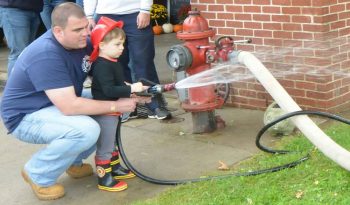 Longwood Fire Company Chief A. J. MaCarthy gives instructions to his son Jeremy during open house event.