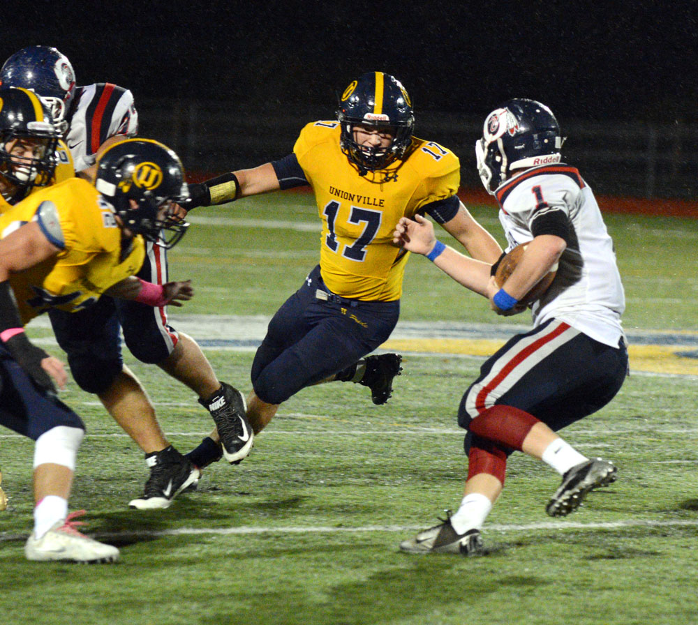 Unionville's Jesse Gill closes in on Octorara's Damien Fahy. Gill and his fellow linebackers James Watson and Trevor Gardiner powered a strong Indians' defense, Friday night. Alex Castina photo.