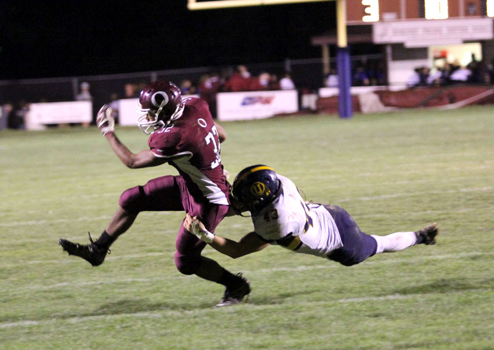 Unionville's Trevor Gardiner makes an impressive open field tackle of Oxford's Tim Davis. Jim Gill photo.