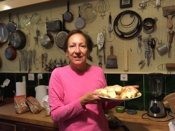 The author, posing with the famous pegboard that husband Paul Child created for French Chef Julia Child in the 1960’s.